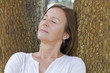 Mature woman relaxed closed eyes outdoor