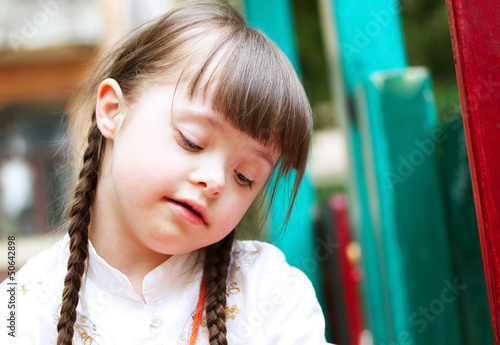 Photo: Portrait of beautiful young girl on the playground. Portrait of beautiful young girl on the playground.