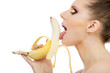 close-up female mouth licking peeled banana, isolated on white