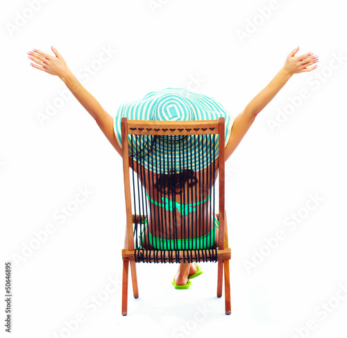 Photo: Woman relaxing on the beach. Woman relaxing on the beach.