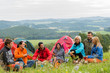 Photo: Sitting camping friends with tents and landscape Sitting camping friends with tents and landscape