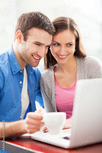 Photo: Couple looking at laptop Couple looking at laptop