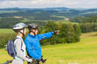 Pointing cyclists couple on summer weekend nature
