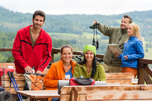 Photo: Friends hikers relax rest place mountain view Friends hikers relax rest place mountain view