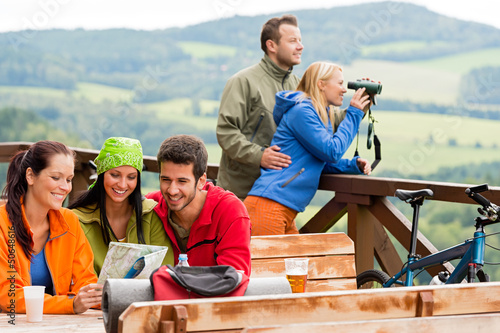Photo: Friends hiking mountains read map look binoculars Friends hiking mountains read map look binoculars