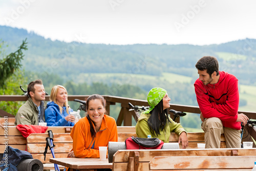 Photo: Talking friends enjoying mountain view rest place Talking friends enjoying mountain view rest place