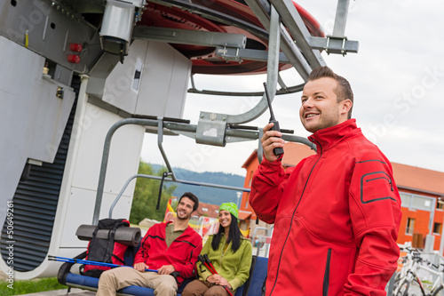 Photo: Man using radio starting chair lift Man using radio starting chair lift