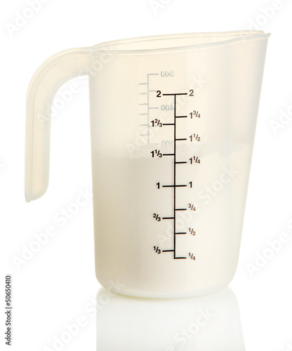 Photo: Measuring cup with flour isolated on white Measuring cup with flour isolated on white