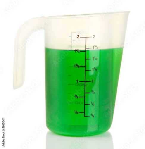 Photo: Measuring cup with green liquid isolated on white Measuring cup with green liquid isolated on white