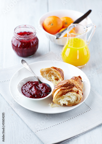 Photo: Croissant with raspberry marmalade on a plate Croissant with raspberry marmalade on a plate