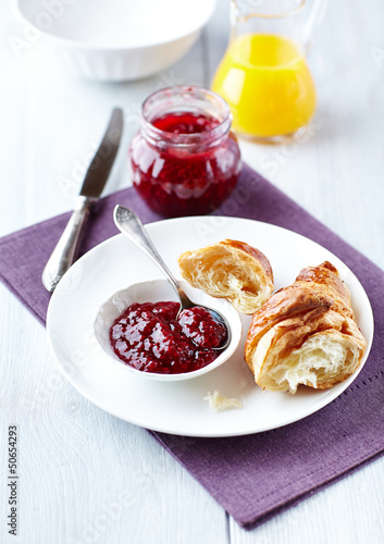 Photo: Croissant with raspberry marmalade on a plate Croissant with raspberry marmalade on a plate