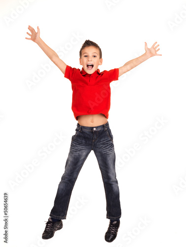 Photo: Happy boy jumping with raised hands up Happy boy jumping with raised hands up