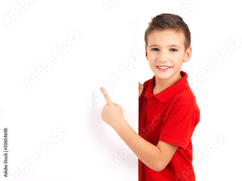 Photo: Portrait of cheerful boy pointing on white banner Portrait of cheerful boy pointing on white banner