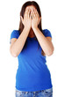 Teen woman covering her face