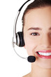 Photo: Beautiful young call-center assistant smiling Beautiful young call-center assistant smiling