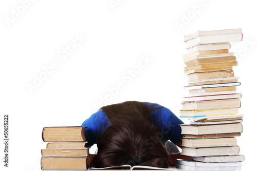 Photo: Teenage girl studying at the desk being tired Teenage girl studying at the desk being tired