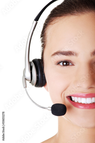 Photo: Beautiful young call-center assistant smiling Beautiful young call-center assistant smiling