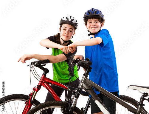 Photo: Cyckists - boy and girl isolated on white background Cyckists - boy and girl isolated on white background