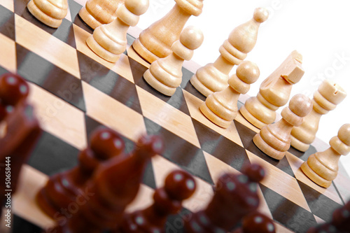 Photo: wooden chess pieces on the board wooden chess pieces on the board