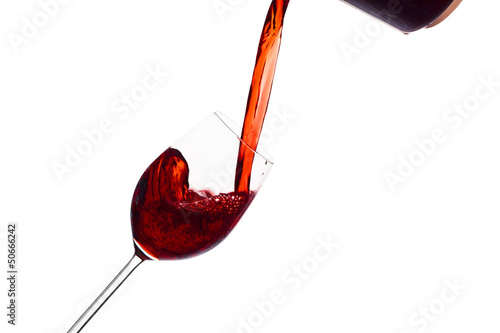 Photo: Rotwein wird in ein Weinglas eingegossen Rotwein wird in ein Weinglas eingegossen
