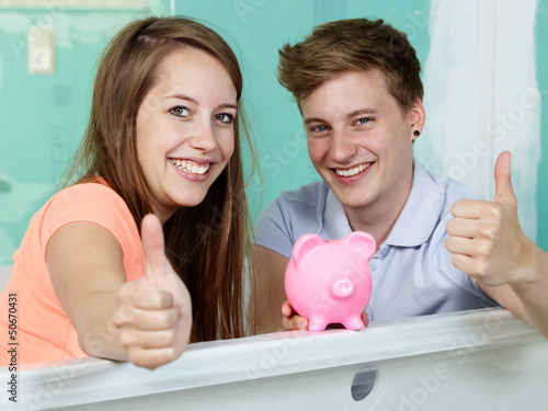 Photo: Couple sit in the bathtub of their site showing thumbs up Couple sit in the bathtub of their site showing thumbs up