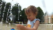 Cute little girl playing at water park