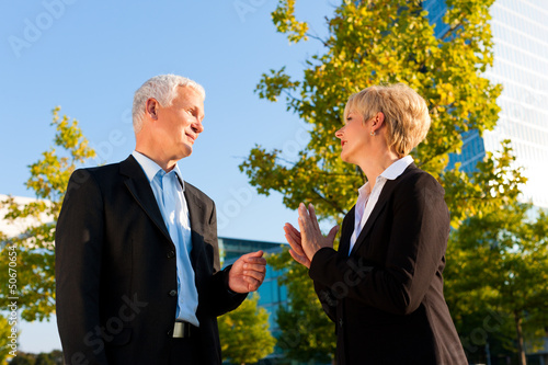 Photo: Business people talking outdoors Business people talking outdoors