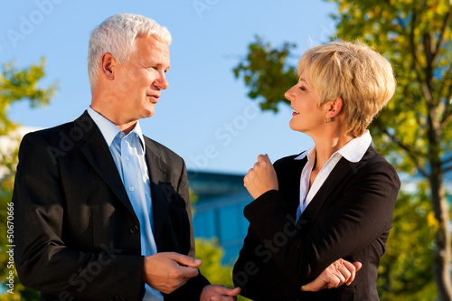 Photo: Business people talking outdoors Business people talking outdoors