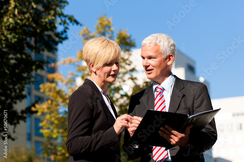 Photo: Business people talking outdoors Business people talking outdoors