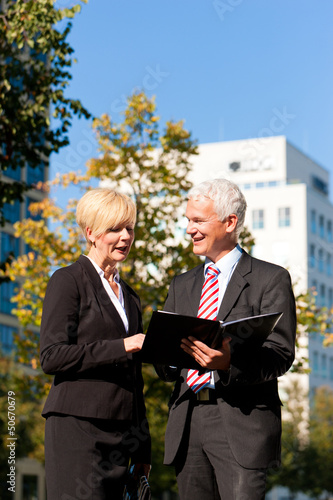 Photo: Business people talking outdoors Business people talking outdoors