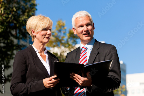 Photo: Business people talking outdoors Business people talking outdoors