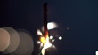 a sparkler being ignited making abstract pattern in slow motion