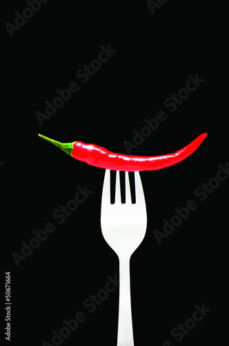 Photo: Red pepper isolated on the black background Red pepper isolated on the black background