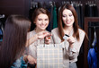Foto: Pretty women pay a bill with credit card Pretty women pay a bill with credit card