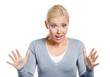 Shocked female with her mouth opened spread hands