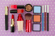 Decorative cosmetics on purple background