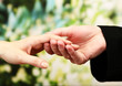 Priest holding woman hand, on green background