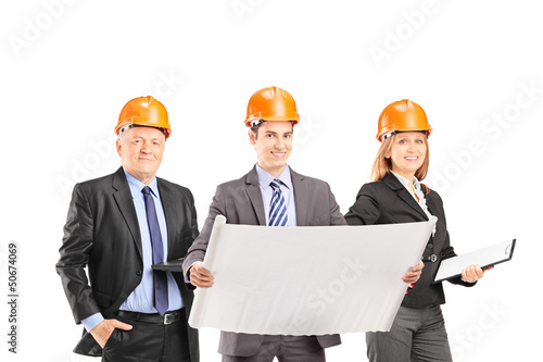 Photo: Team of successful engineers with helmets Team of successful engineers with helmets