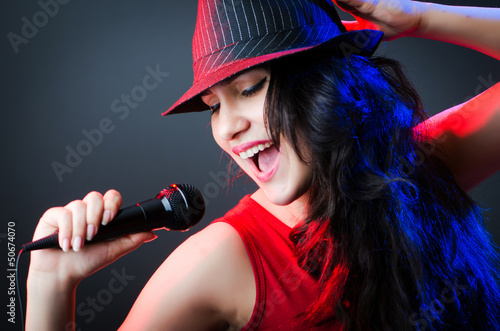 Photo: Female performer at disco with mic Female performer at disco with mic