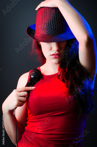 Photo: Female performer at disco with mic Female performer at disco with mic