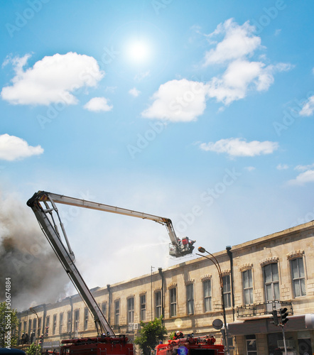 Photo: Boom of a firetruck during fire in the city Boom of a firetruck during fire in the city