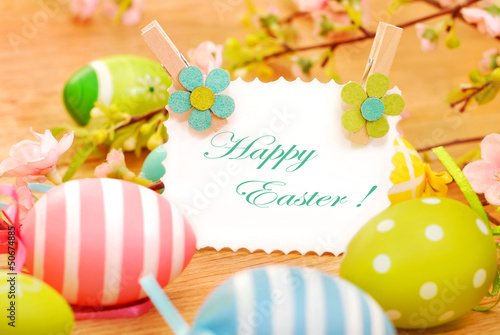 Photo: easter eggs and greetings card on wooden background easter eggs and greetings card on wooden background