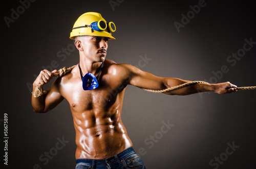 Photo: Nude builder pulling rope in darkness Nude builder pulling rope in darkness