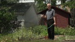 Man watering his backyard garden, slow motion shot