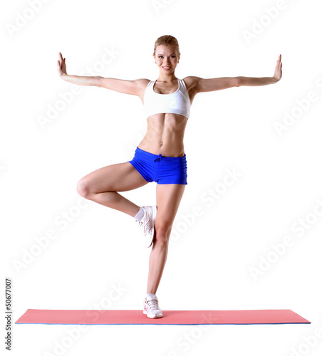 Photo: Attractive blonde posing on mat in studio Attractive blonde posing on mat in studio