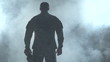 Soldier looking down, surrounded by smoke