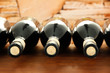 Wine bottles on wooden table, on stone background