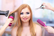 Beautiful woman and hands with brushes, scissors and hairdryer