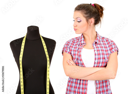 Photo: Beautiful young dressmaker and mannequin isolated on white Beautiful young dressmaker and mannequin isolated on white