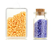 Colorful beads heap in box and glass bottle isolated on white